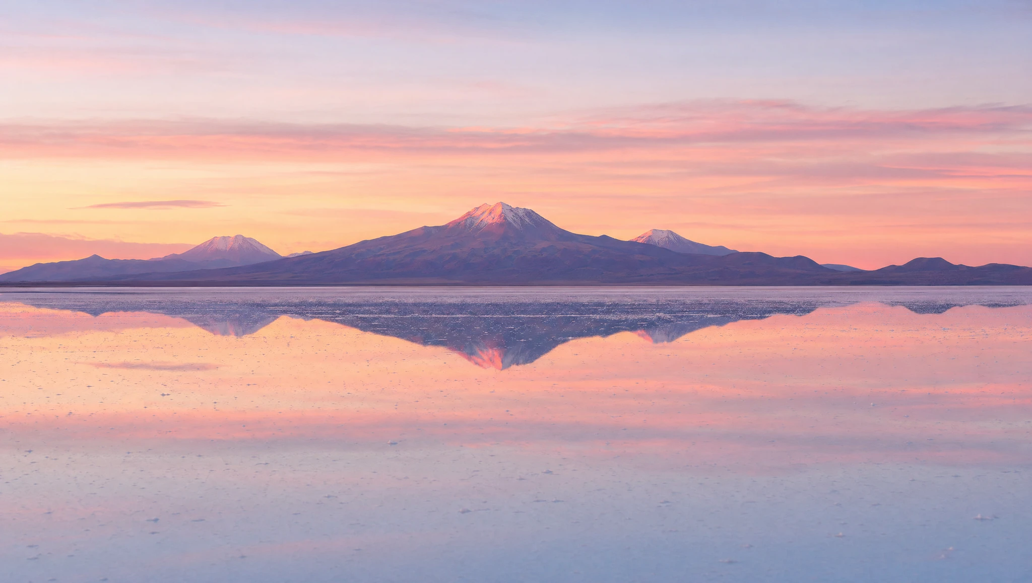 Salar de Uyuni salt flats stretching to the horizon under a wide sky, Bolivia