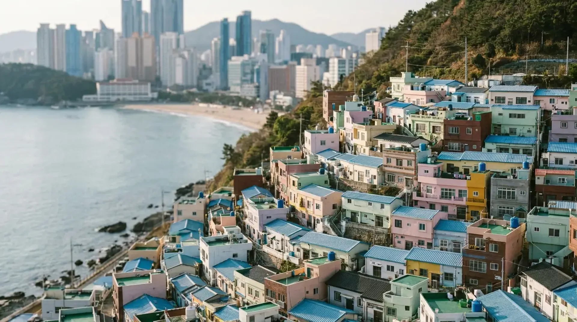 Gamcheon Culture Village pastel hillside houses above Haeundae beach and skyline, Busan, South Korea