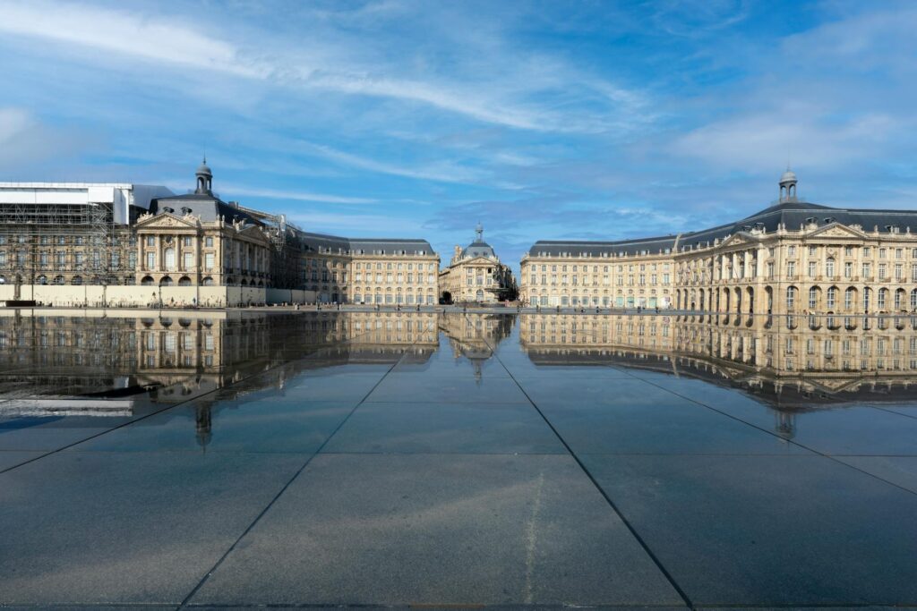 Neoclassical Place de la Bourse mirrored in the Miroir d'eau water feature, Bordeaux, France