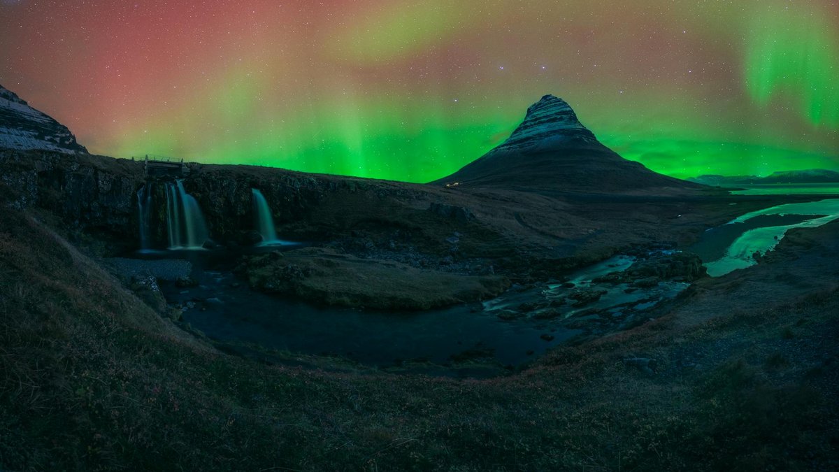 Iceland — Kirkjufell mountain (463 m) and Kirkjufellsfoss waterfall on the Snæfellsnes Peninsula with aurora borealis overhead (iceland-kirkjufell-aurora)