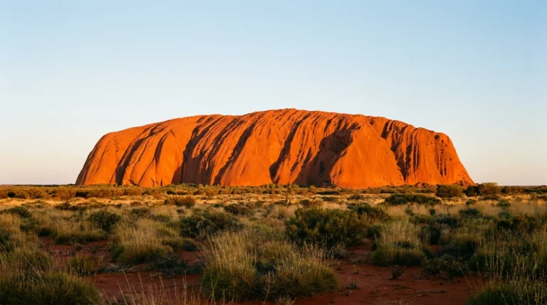 Australia — Uluru (Ayers Rock) glowing red at sunset in the outback