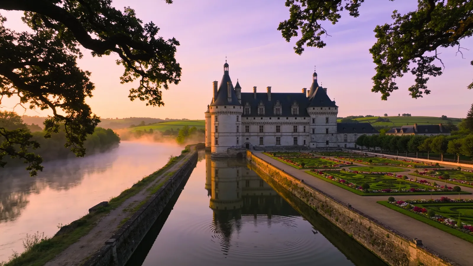 Renaissance château reflected in the river in the Loire Valley at sunrise