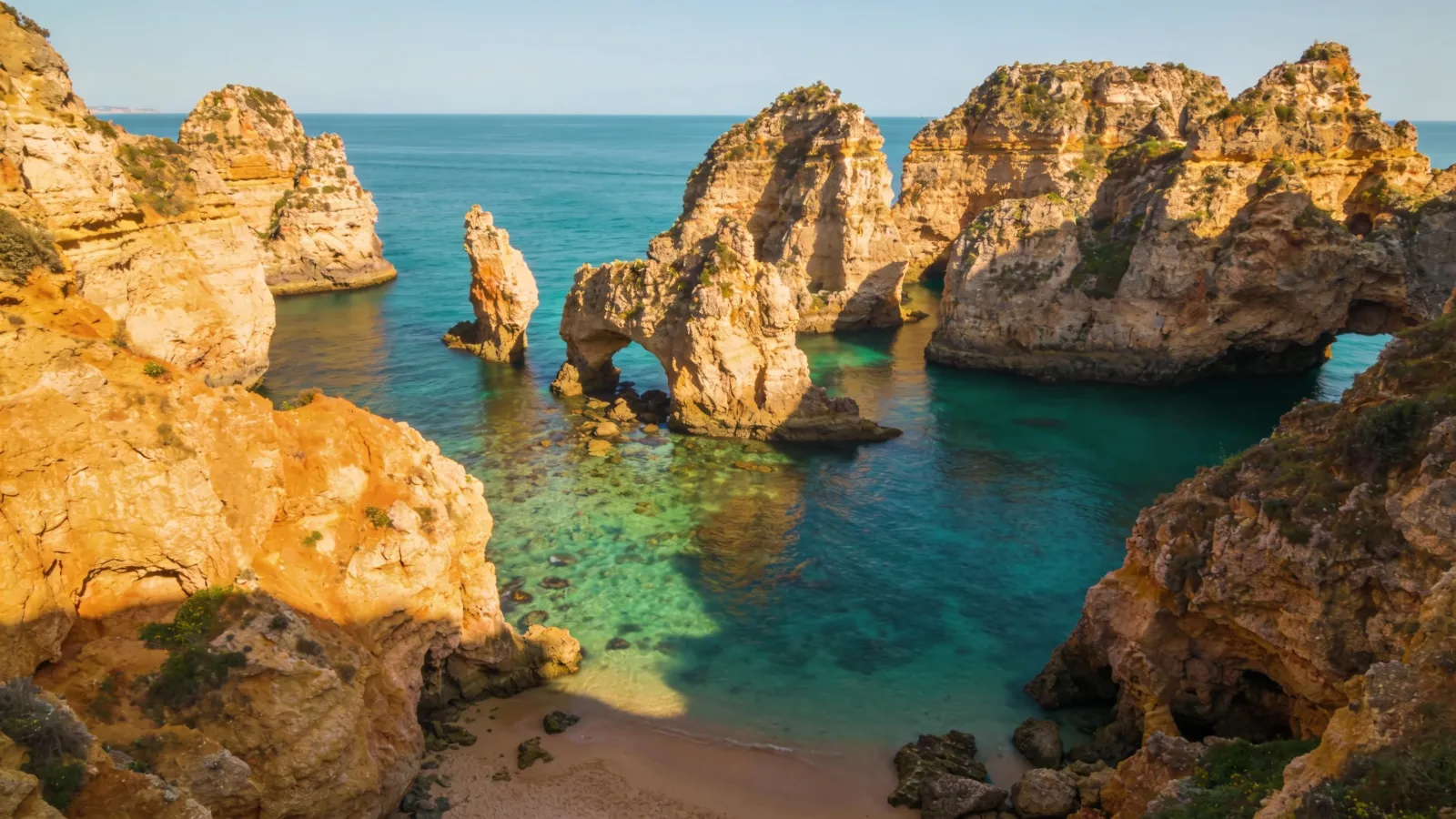 Golden sea cliffs and clear water on the Algarve coast