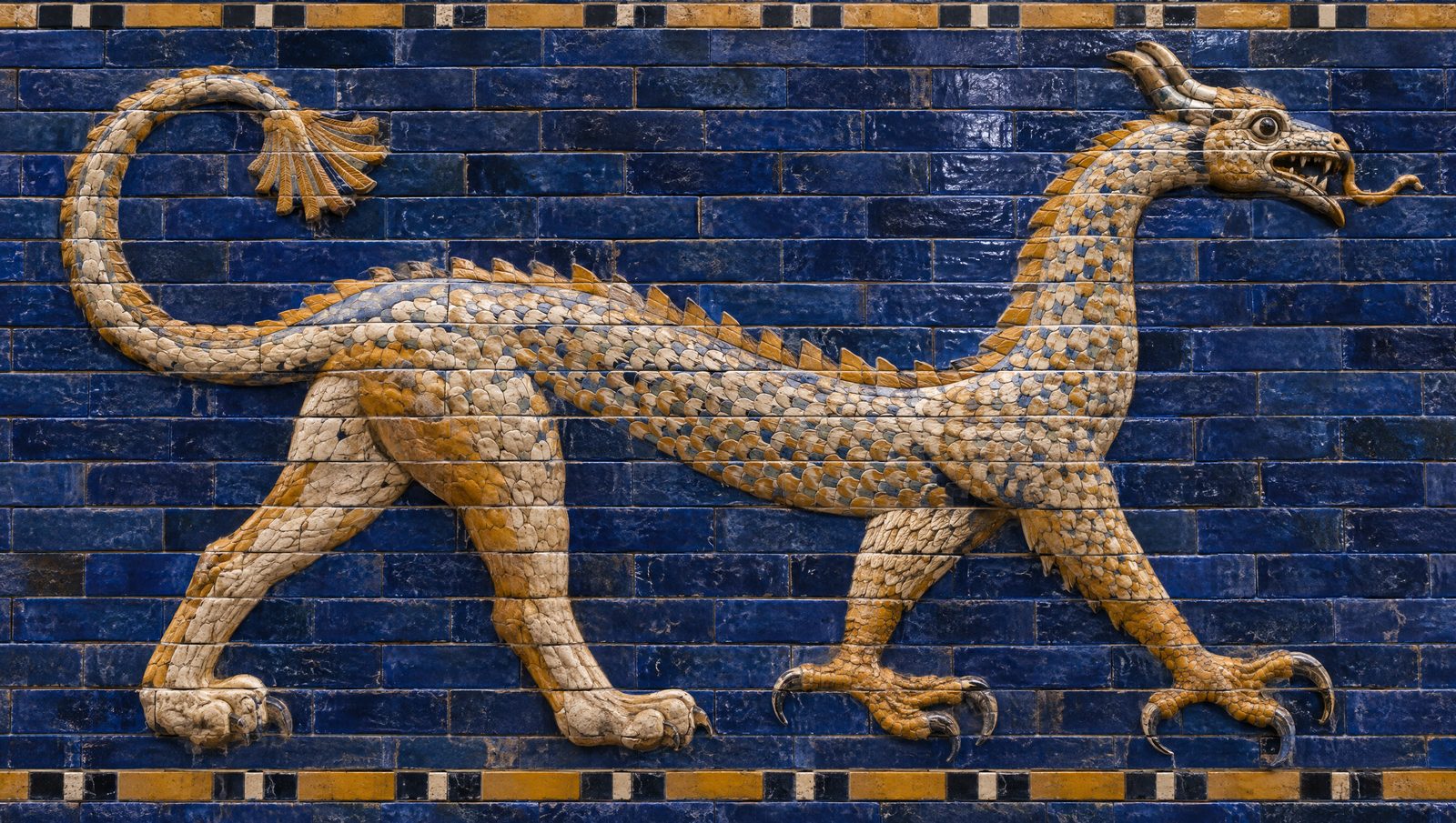 A glazed-brick relief of a striding mushhushshu dragon in cream and ochre against deep blue bricks from the Ishtar Gate of Babylon