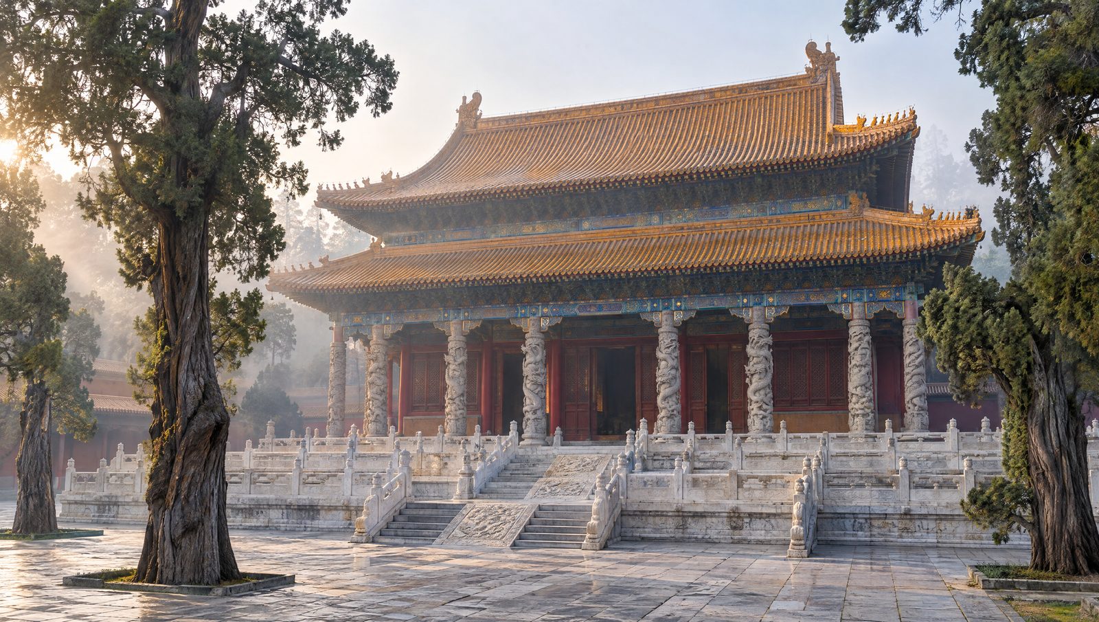 The Dacheng Hall of the Temple of Confucius in Qufu with its double-eaved yellow-tiled roof, marble terrace and ancient cypresses